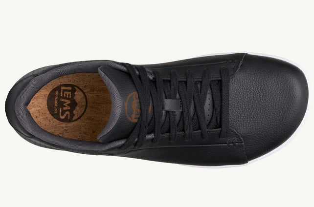 Top view of black Lems Kourt casual sneaker with black laces and wooden-textured insole.