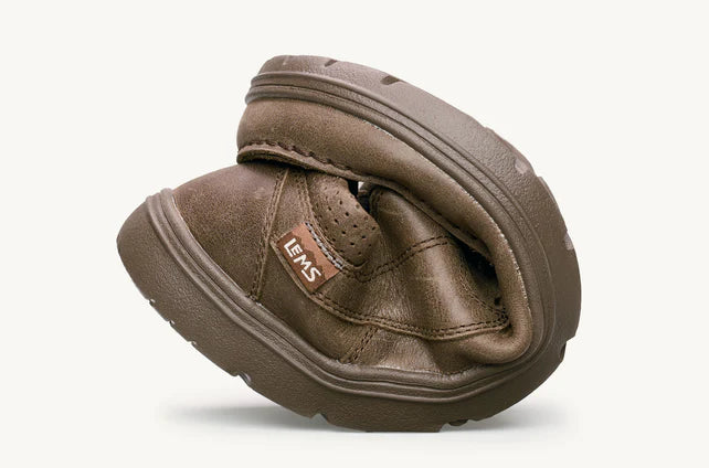 Folded brown leather casual slip-on shoe with textured sole and Lems logo tag.