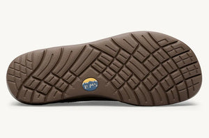 Brown rubber outsole with textured geometric tread pattern and small blue circular logo in center.