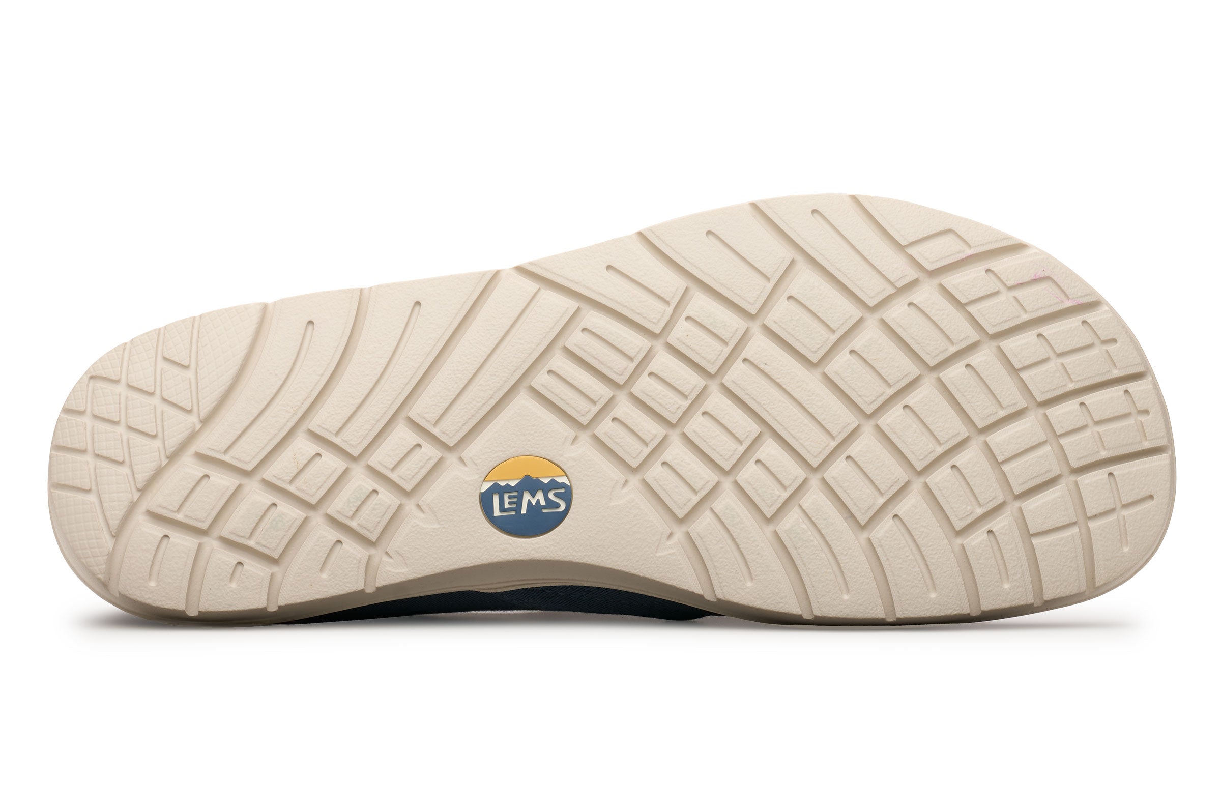 Beige rubber outsole with multidirectional tread pattern and small Lems logo near the heel.