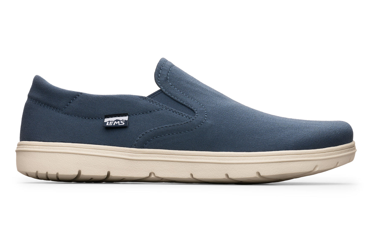 Navy blue slip-on casual shoe with elastic side panels and beige rubber sole.