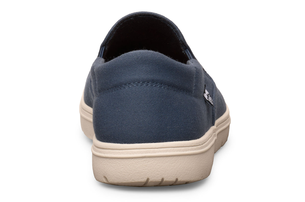 Navy blue casual slip-on shoe with beige sole, rounded heel, and minimalist design.