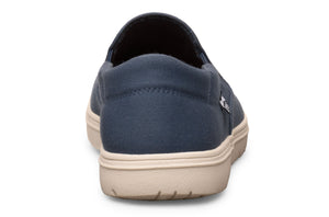Navy blue casual slip-on shoe with beige sole, rounded heel, and minimalist design.
