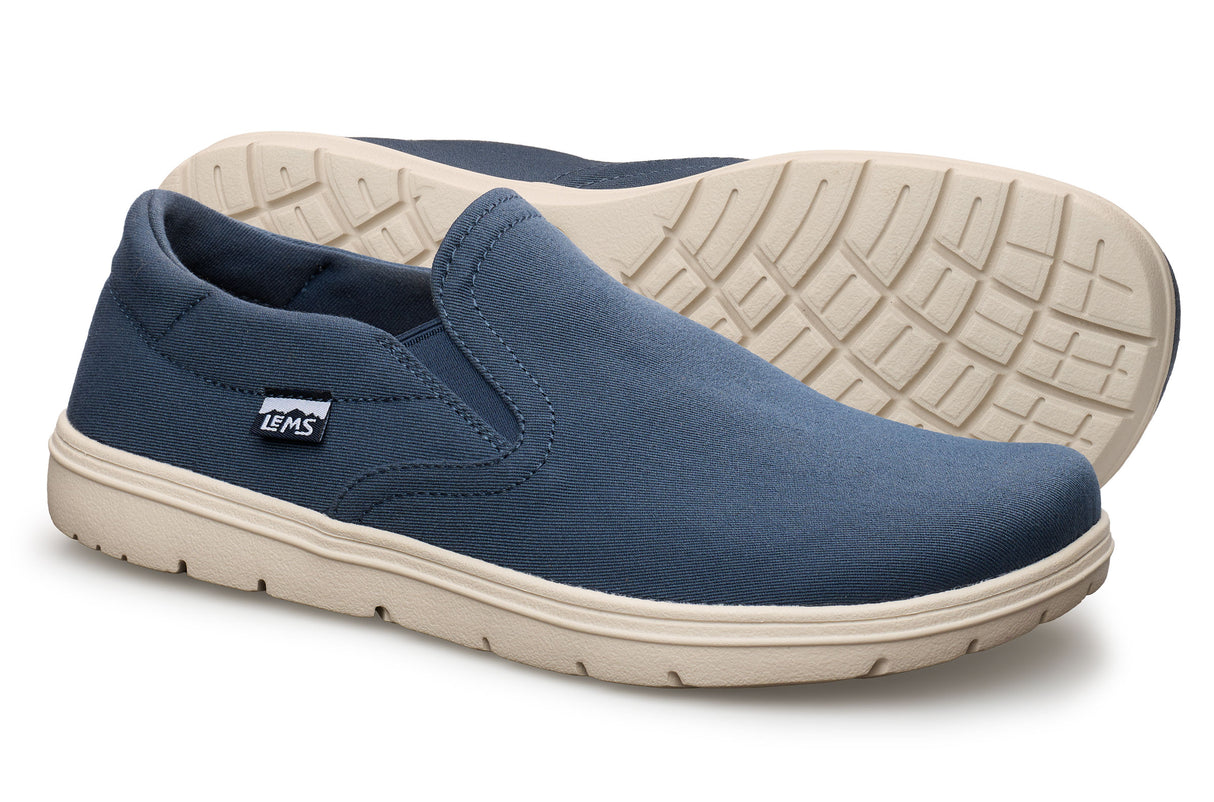 Navy blue slip-on casual shoe with beige sole and elastic side panels.
