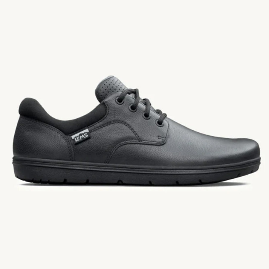 Black minimalist casual leather shoe with lace-up closure and rubber sole.