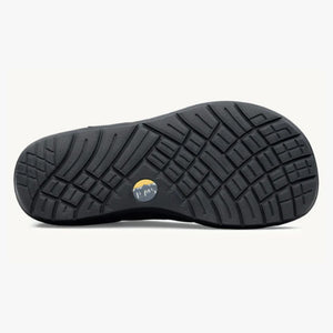 Black rubber outsole with deep multidirectional treads and circular Lems logo near the arch.