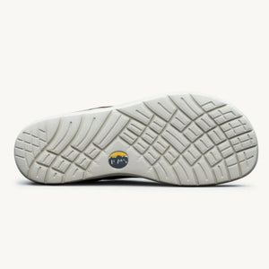 Cream-colored shoe sole with deep tread pattern and circular Lems logo in center.