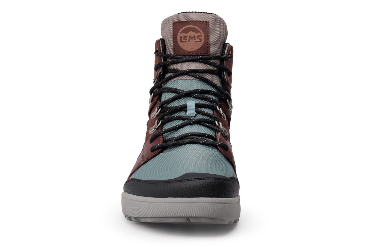 Lems Outlander waterproof boot in iceberg blue with brown accents, black laces, and rubber toe cap, front view.