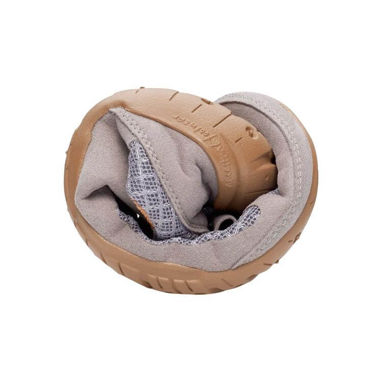 Slate gray flexible sneaker folded to showcase soft, cushioned interior and rubber sole.