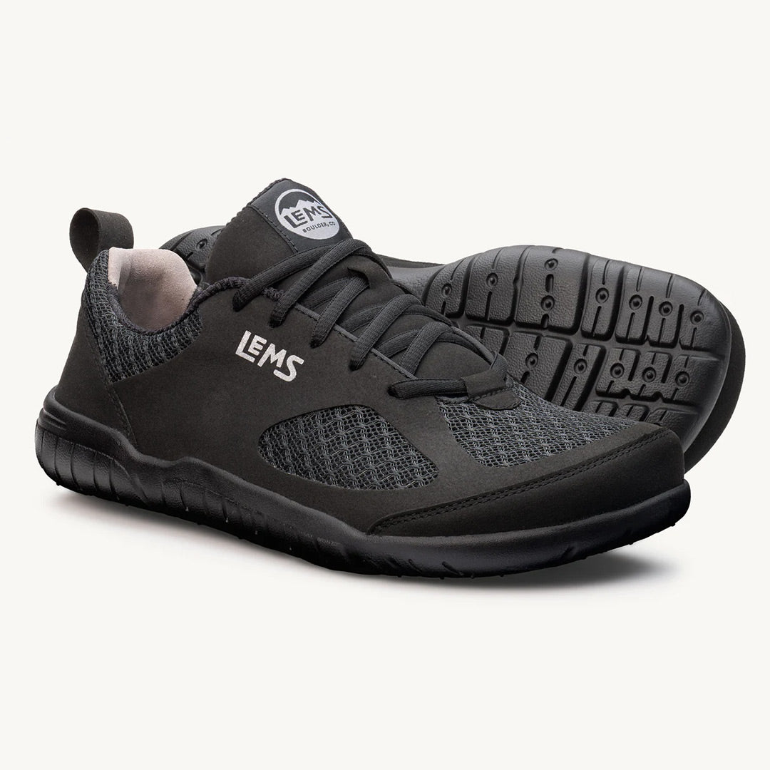Black athletic sneaker with knit upper, Lems logo on side, and flexible rubber sole.