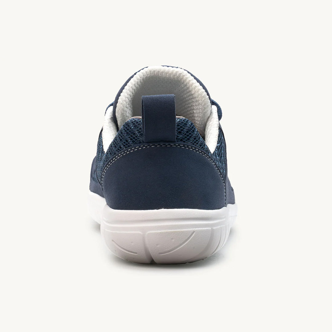 Navy blue athletic sneaker with white sole and padded collar, rear view.
