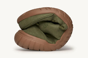 Olive green flexible athletic shoe folded to show soft, pliable sole and upper.