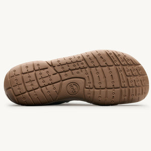 Brown rubber sole with flexible grooves and textured grip pattern on Lems Primal 3 shoe.