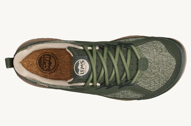 Green lace-up athletic shoe with textured knit upper and cushioned tan interior lining.