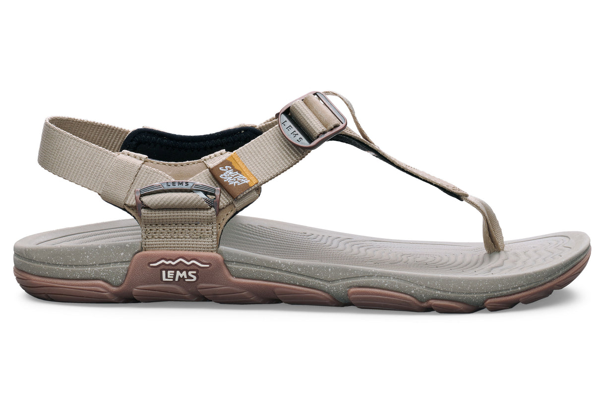 Beige Lems Switchback sandal with adjustable straps and cushioned sole in neutral tones.