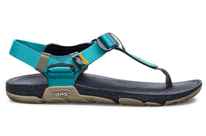 Teal and black casual sandal with adjustable straps and textured sole.