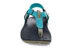 Teal and beige casual sandal with adjustable strap and textured black footbed.