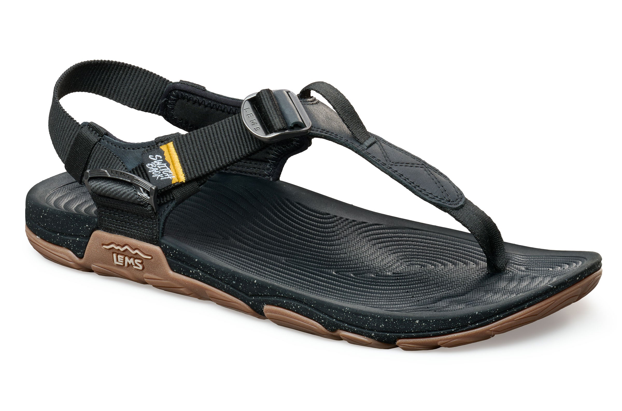 Black Lems Switchback Scorpion sandals with adjustable ankle strap and toe loop on textured sole.