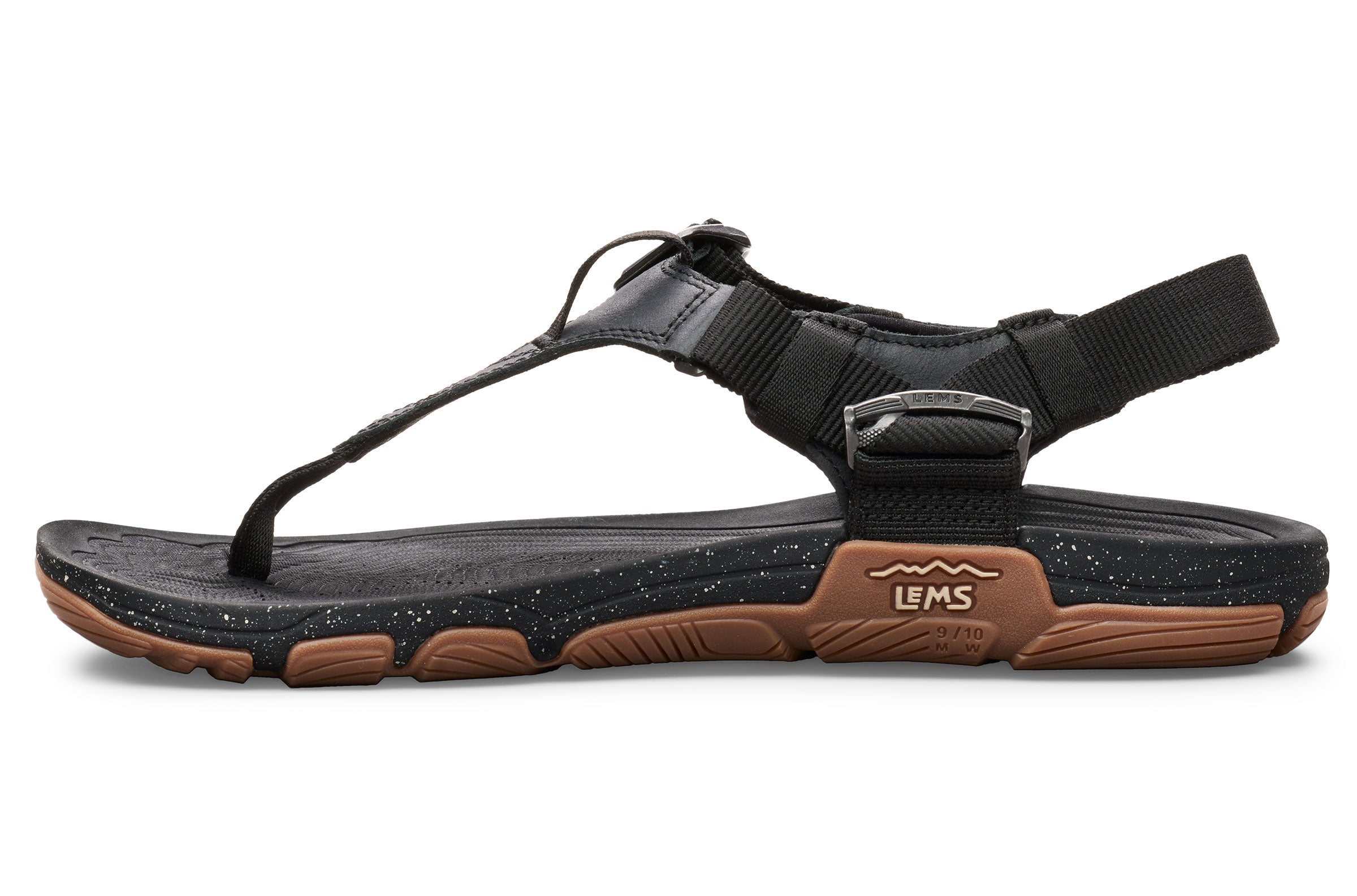 Black open-toe Lems Switchback sandal with adjustable straps and brown textured sole.