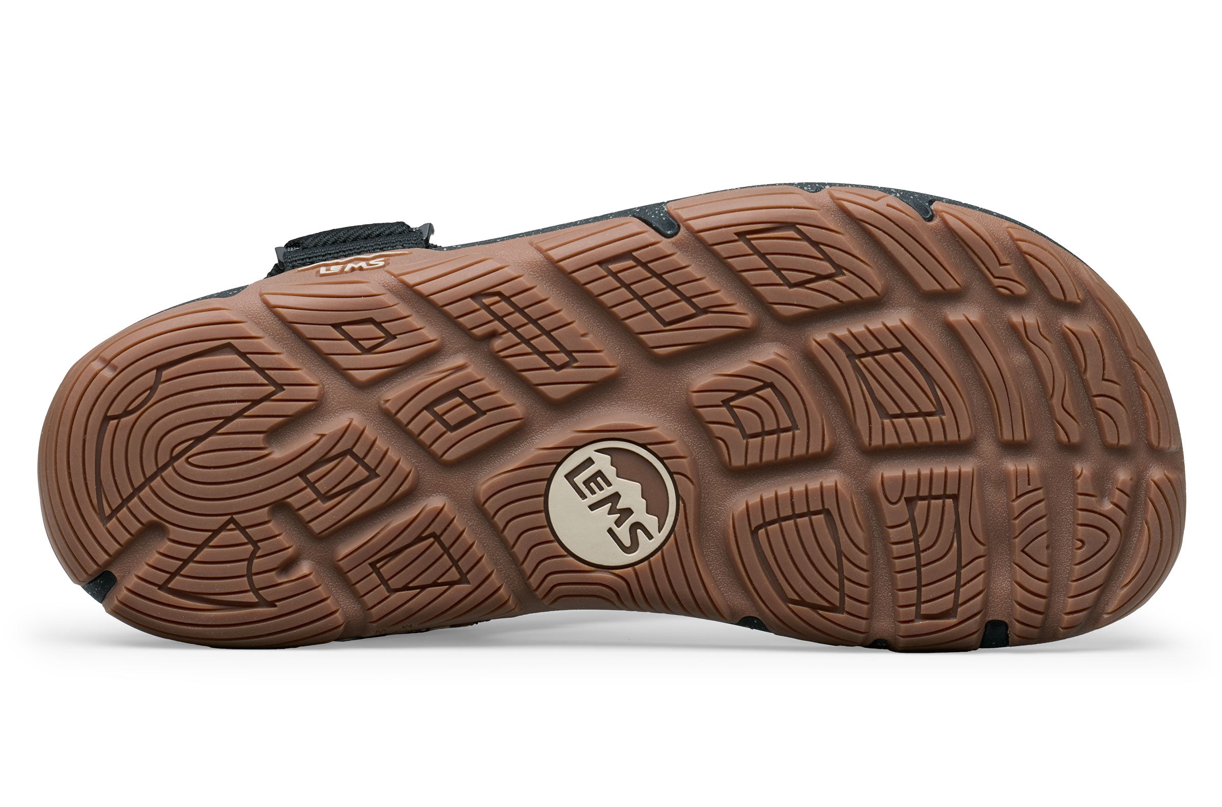 Brown rubber sole of Lems Switchback sandal with deep tread pattern and Lems logo in the center.
