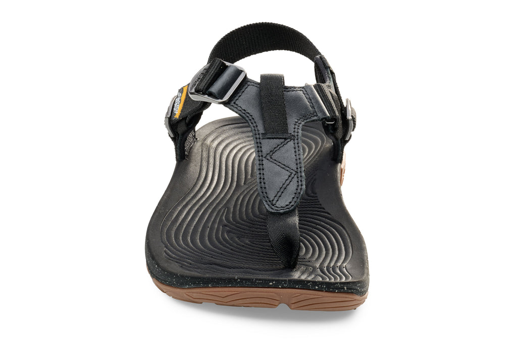 Black leather toe-loop sandal with adjustable buckle strap and textured sole.