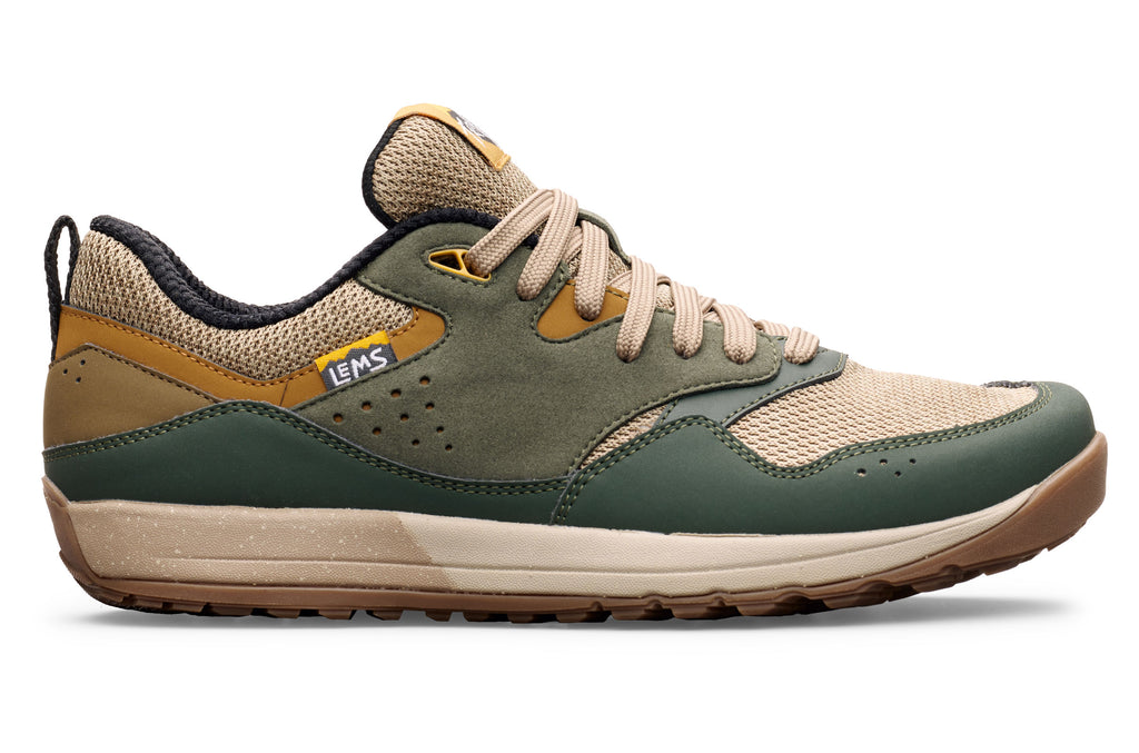 Low-profile trail shoe in green and tan with breathable mesh, suede overlays, and beige laces.