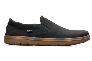 Black slip-on casual shoe with brown rubber sole and a small side Lems logo tag.