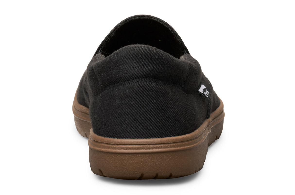 Black casual slip-on shoe with brown rubber sole, rounded heel, and fabric upper.
