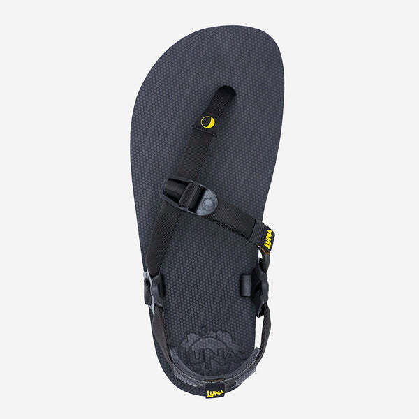 Black Luna Sandals Mono Winged Edition with minimalist strap and adjustable buckle on textured sole.
