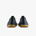 Pair of dark blue sneakers with brown soles on a white background