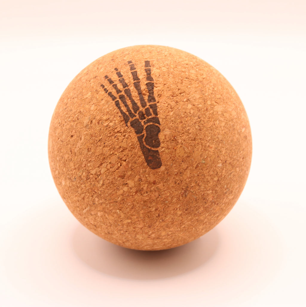 A round cork massage ball with a dark brown printed skeletal foot design, shown on a clean white background.