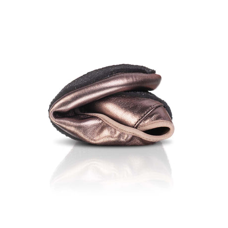 Folded bronze metallic barefoot ballerina shoe with soft, flexible sole on white background.