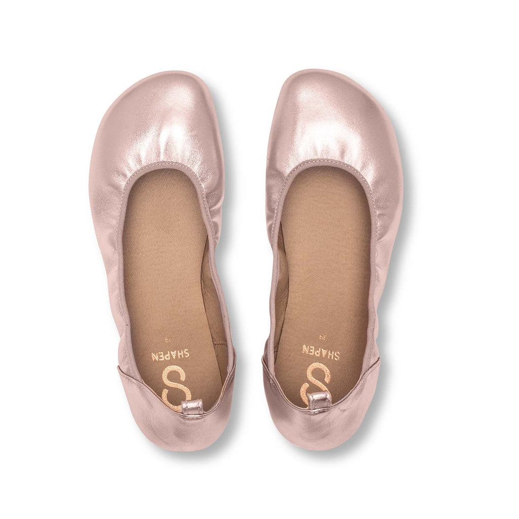 Rose gold wide ballerina flats with rounded toe and soft, gathered leather upper.