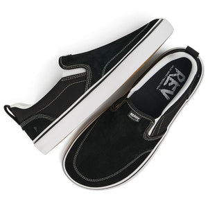Black slip-on shoes with white soles on a white background