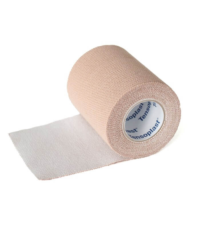 Beige cohesive elastic bandage roll partially unrolled with white inner core labeled Tensoplast.