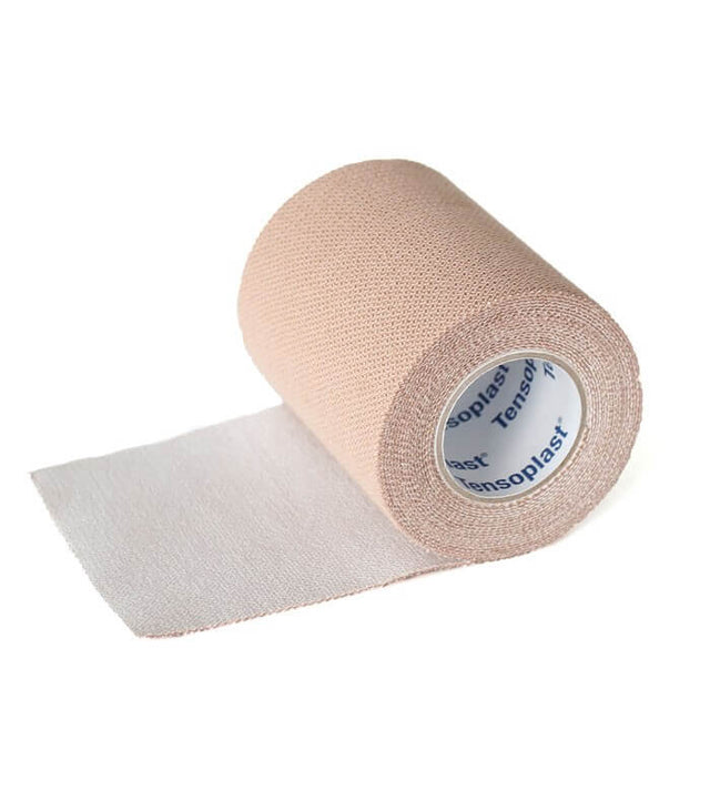 Beige cohesive elastic bandage roll partially unrolled with white inner core labeled Tensoplast.