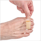 Narrow beige fabric toe loop wrapped around a big toe on a bare foot.