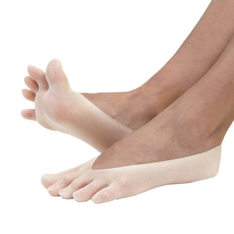 Beige nylon no-show toe socks covering toes and heel with open midfoot design on feet.