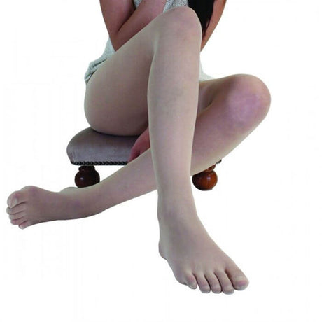 Beige sheer nylon toe tights worn on crossed legs seated on a chair with wooden legs.