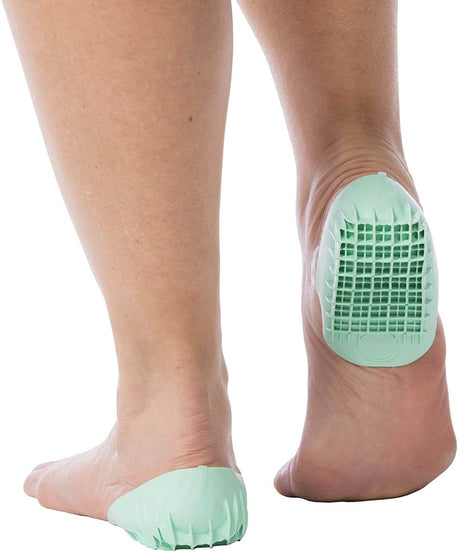 Light green gel heel cup cushioning a bare foot heel with textured grid pattern and flexible edges.
