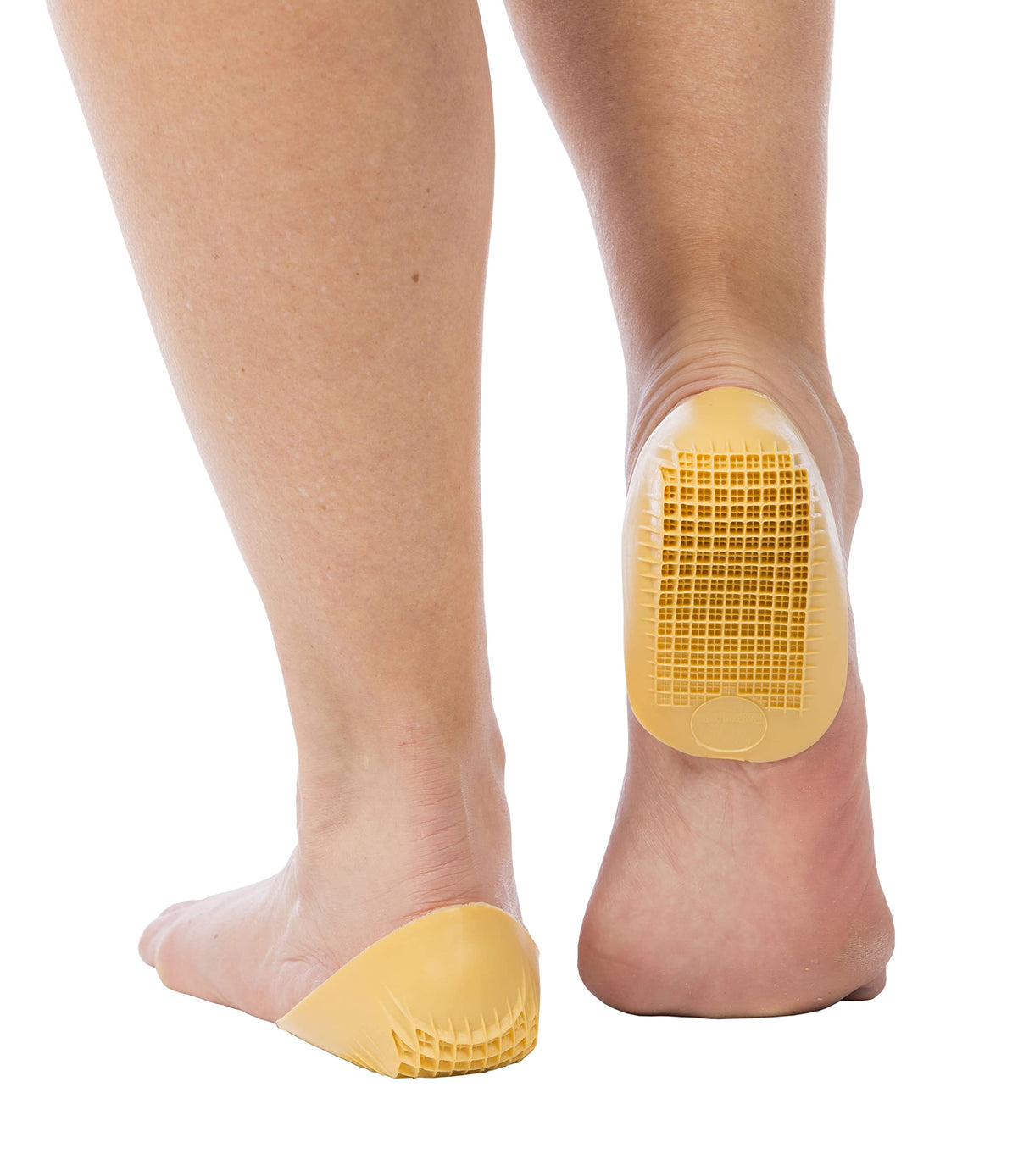 Yellow gel heel cups on bare feet with textured grip pattern on the bottom.