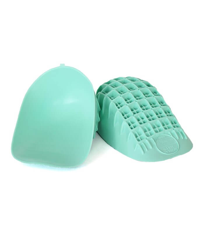 Pair of light green Tuli's heel cups with textured grid pattern on the sole and smooth top surface.