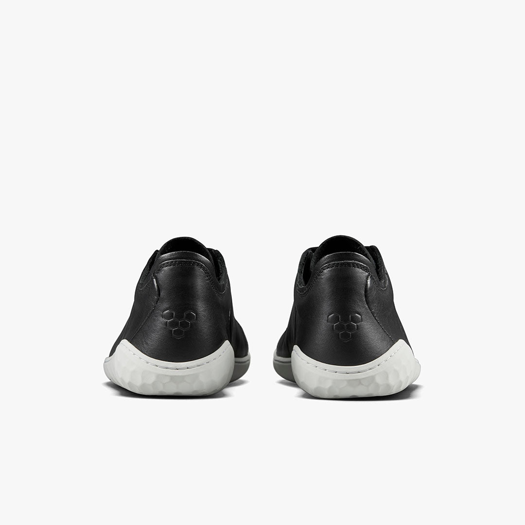 Pair of black leather Vivobarefoot Geo Court III sneakers shown from the back with white soles.