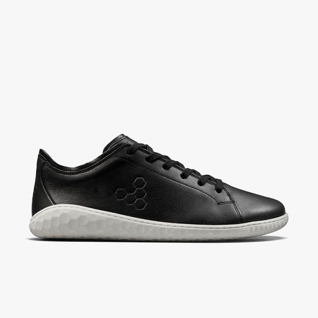 Black leather low-top sneaker with textured white sole and subtle embossed logo on side.