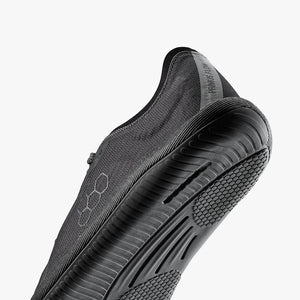 Dark shadow Vivobarefoot men's athletic shoe with textured sole and hexagonal pattern on side.