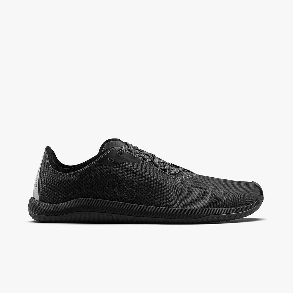 All-black low-profile athletic shoe with mesh upper and minimalistic design, sleek sole.