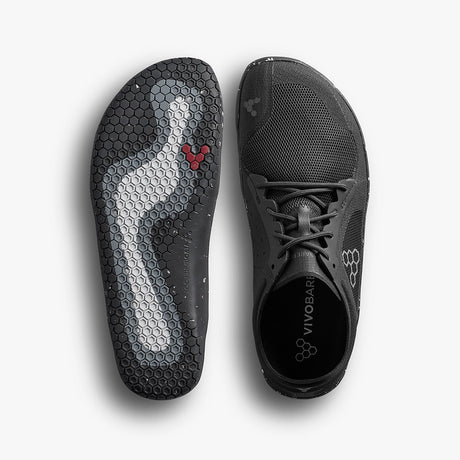 Black Vivobarefoot Primus Lite 3.5 sneaker with breathable mesh upper and flexible sole featuring hexagonal traction pattern.