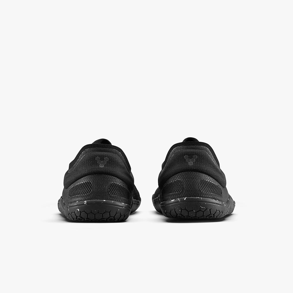 Pair of black Vivobarefoot Primus Lite 3.5 athletic shoes shown from the rear with textured soles and minimalist design.