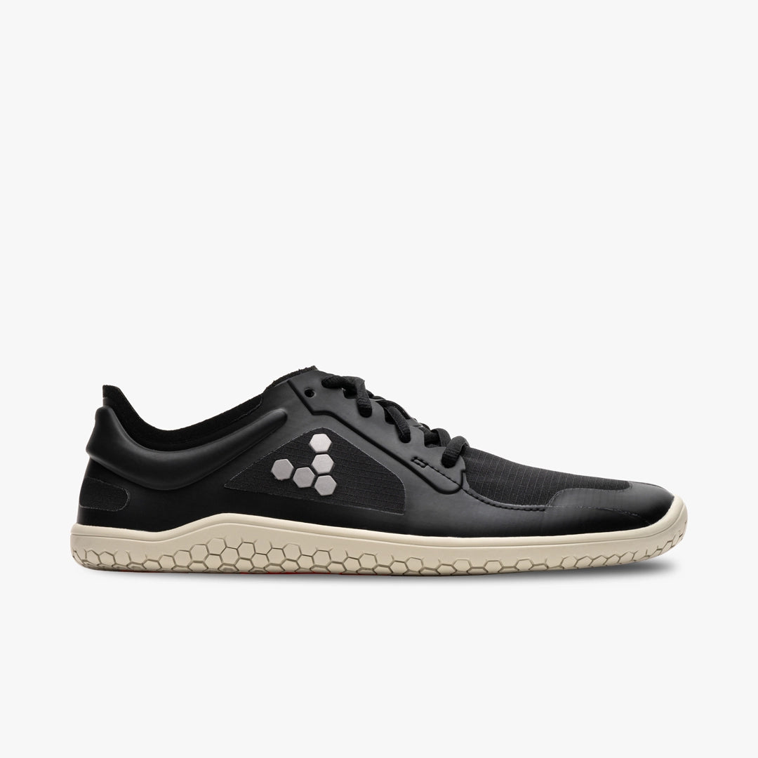 Black Vivobarefoot Primus Lite IV men's sneaker with beige honeycomb-patterned sole and minimalist design.