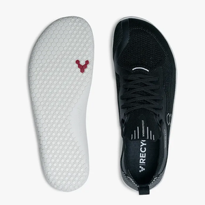 Black knitted athletic shoe with laces and white honeycomb-patterned sole with red logo.